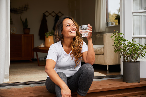 Happy woman sitting on her porch.