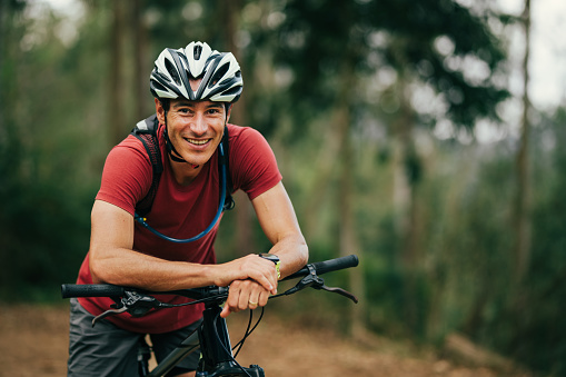 Happy cyclist in the woods.